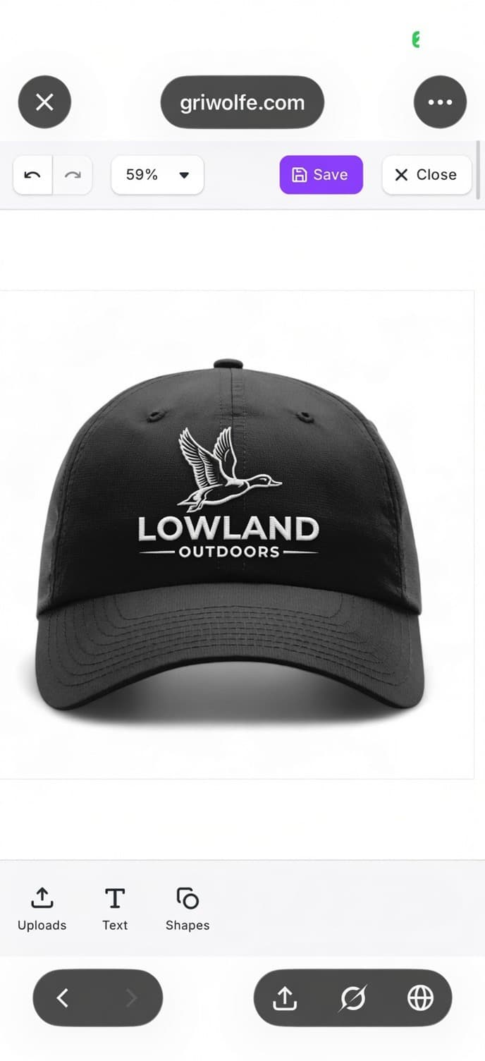 Black baseball cap with white embroidered flying duck logo and "LOWLAND OUTDOORS" text.